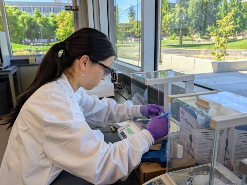 Sophia Zhang weighing a compound in the IPN lab